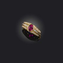 A ruby and diamond ring, set with an oval ruby within diamond-set shoulders in yellow gold, size M