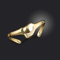 Elsa Peretti for Tiffany & Co, a gold bangle, designed as a stylised heart in polished yellow