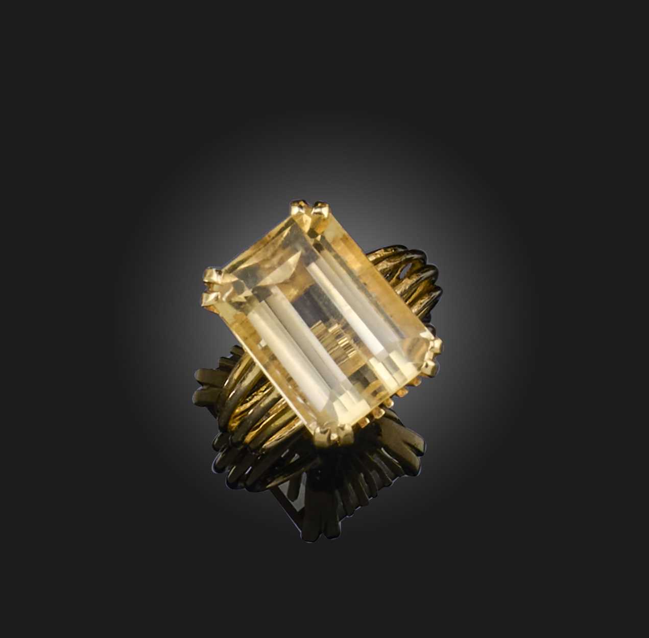 A citrine mounted gold ring, the step-cut citrine claw-set in 18ct yellow gold, size M