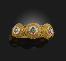 A 19th century Etruscan Revival gold bangle, set with three circular plaques centring on micromosaic