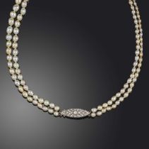 A pearl and diamond necklace, early 20th century, designed as a double strand of graduated pearls