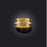 A yellow sapphire and diamond ring, the cushion-shaped yellow sapphire with graduated diamond-set