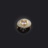 A heart-shaped diamond ring, centring on a glazed heart-shaped compartment containing two free-