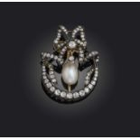 A late 19th century natural pearl and diamond brooch, centring on a drop-shaped pearl within a