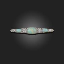 An opal and diamond brooch, early 20th century, of bar design, set with three cabochon opals, spaced