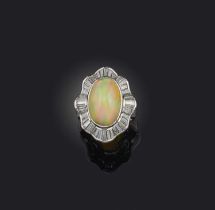 An opal and diamond ring, collet-set with a cabochon opal weighing 5.37 carats, within an undulating