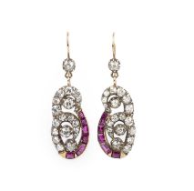 A pair of ruby and diamond earrings, early 20th century composite, each designed as a scroll motif