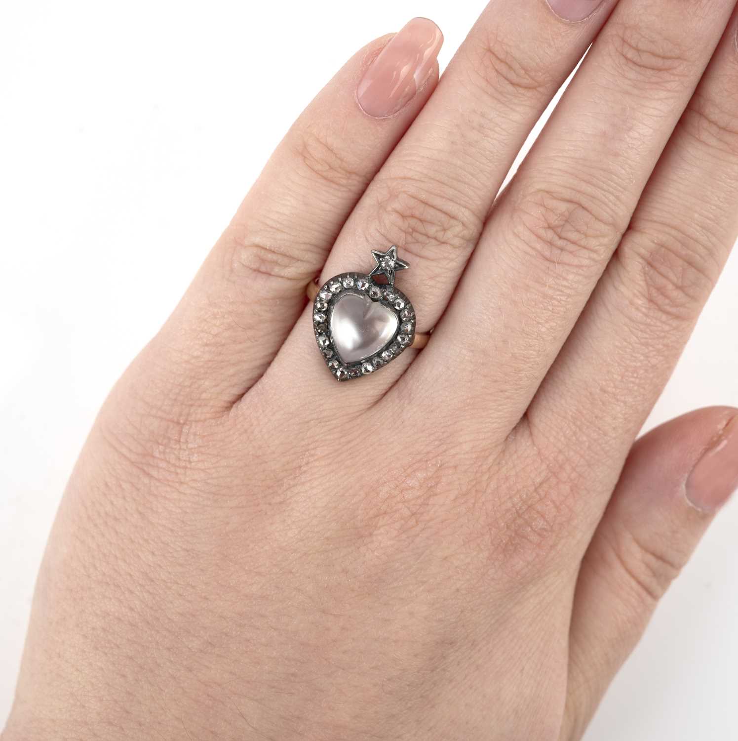 A moonstone and diamond ring, designed as a heart surmounted by a star, set with a polished heart- - Image 2 of 3