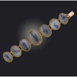 An early 19th century moss agate bracelet, the graduated oval panels within gold twisted rope