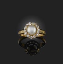 A pearl and diamond ring, late 19th century, centring on a bouton pearl measuring approximately 6.