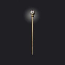 A natural pearl stick pin, France, late 19th/early 20th century, capped with a natural pearl of grey