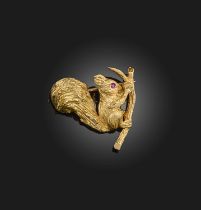 Boucheron, a gold and ruby brooch, mid 20th century, designed as a squirrel on a branch holding a