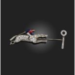 An early 20th century horse and jockey jabot pin, designed as a horse and jockey racing towards