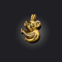 A gem-set and gold koala brooch pendant, with emerald eyes and diamond accents in 18ct yellow