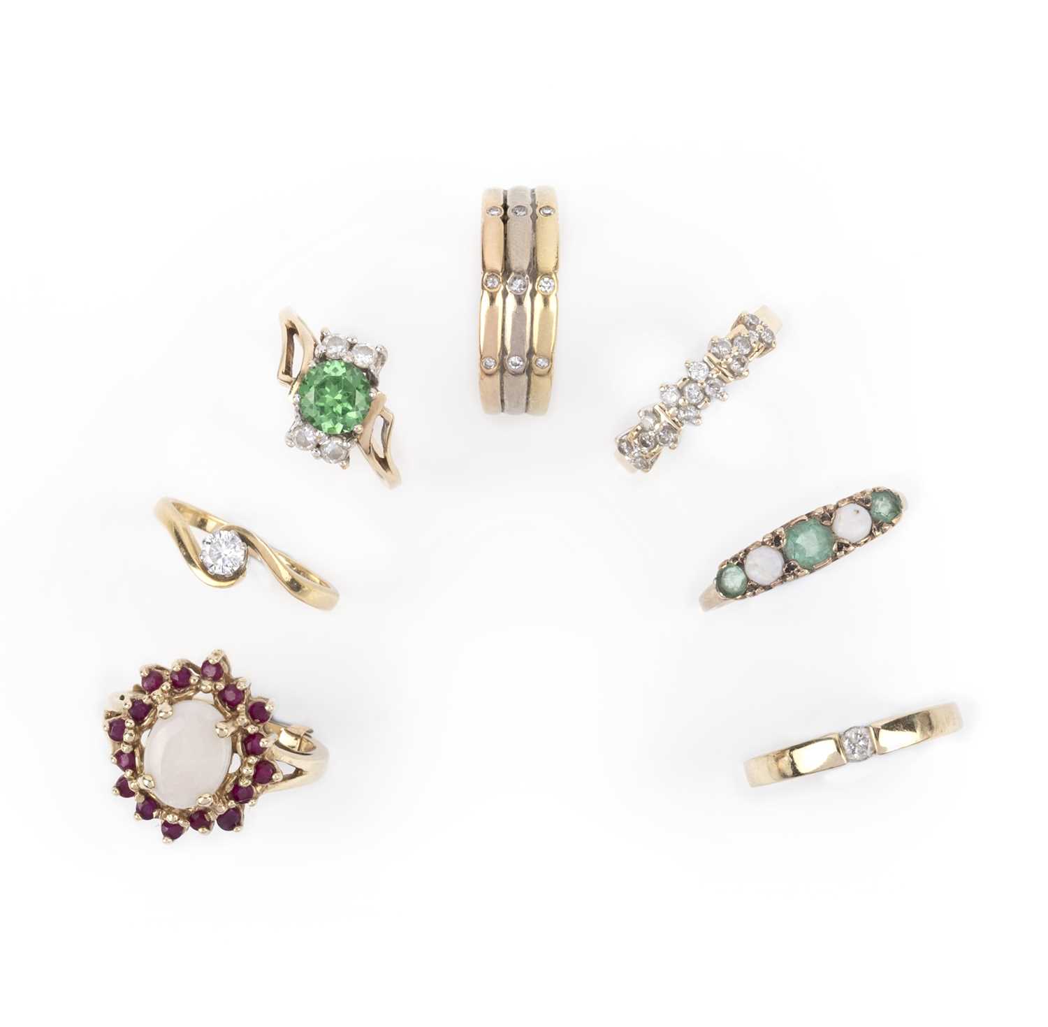 A group of seven gold and gem-set rings, comprising: an opal and ruby cluster ring, size I; a five