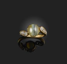 A cat's eye chrysoberyl and diamond ring, late 19th century, set with a cabochon cat's eye