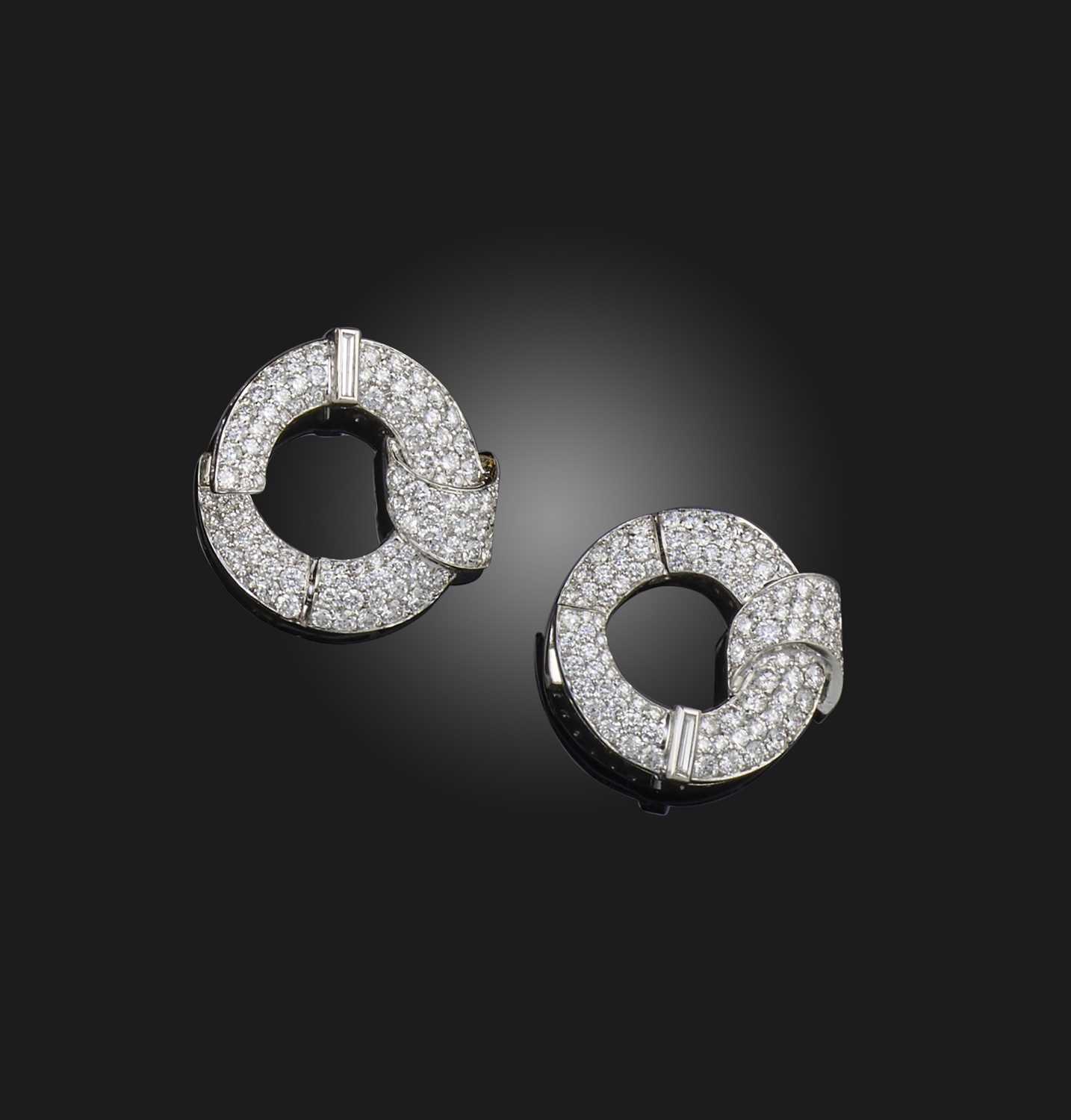 A pair of diamond hoop earrings, set overall with graduated circular-cut diamonds and a baguette-