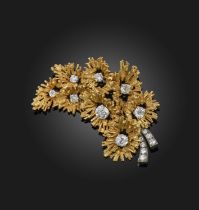 A gold and diamond brooch, 1970s, designed as a spray of flowers in textured gold, set with