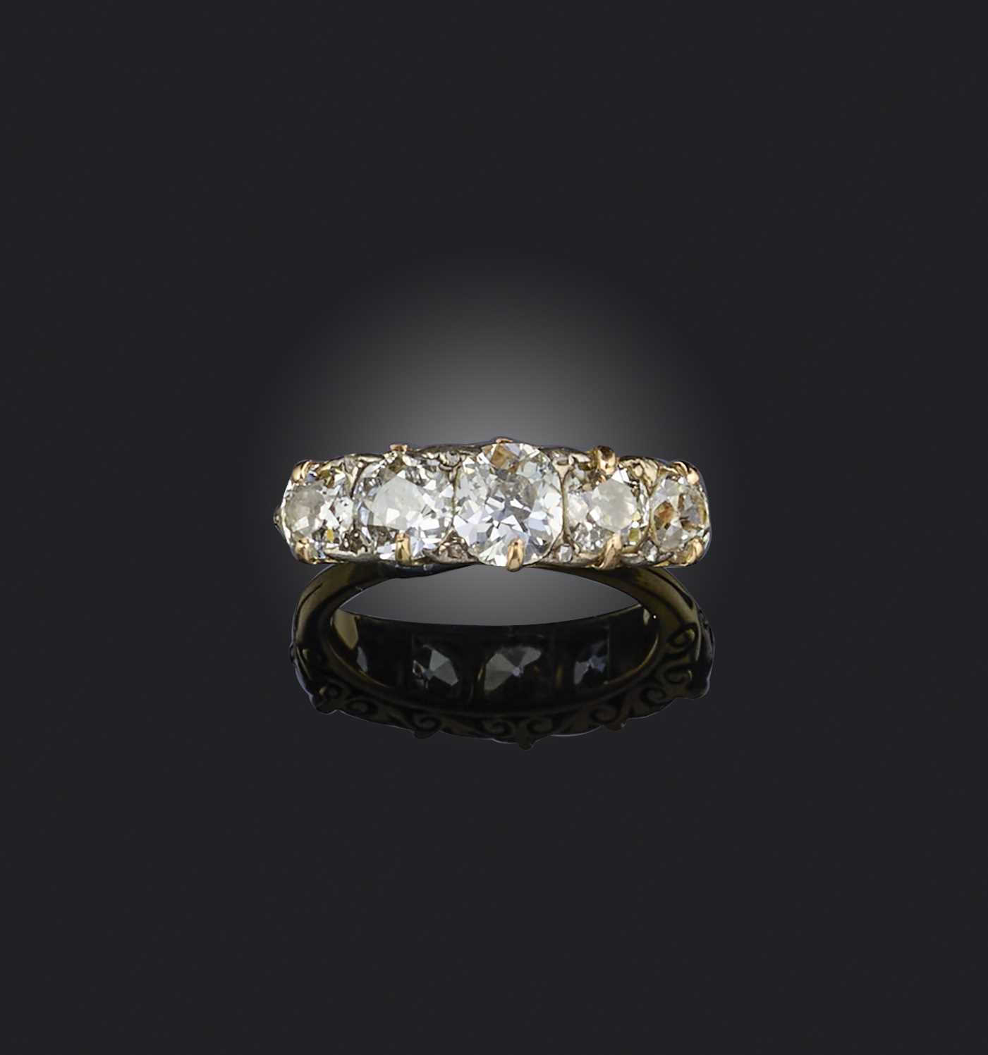 A late 19th century diamond five stone ring, set with graduated old cushion-shaped diamonds and