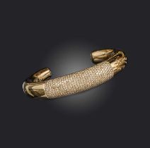 Georg Jensen, a gold and diamond bangle, of torque design, centring on a section of pavé-set