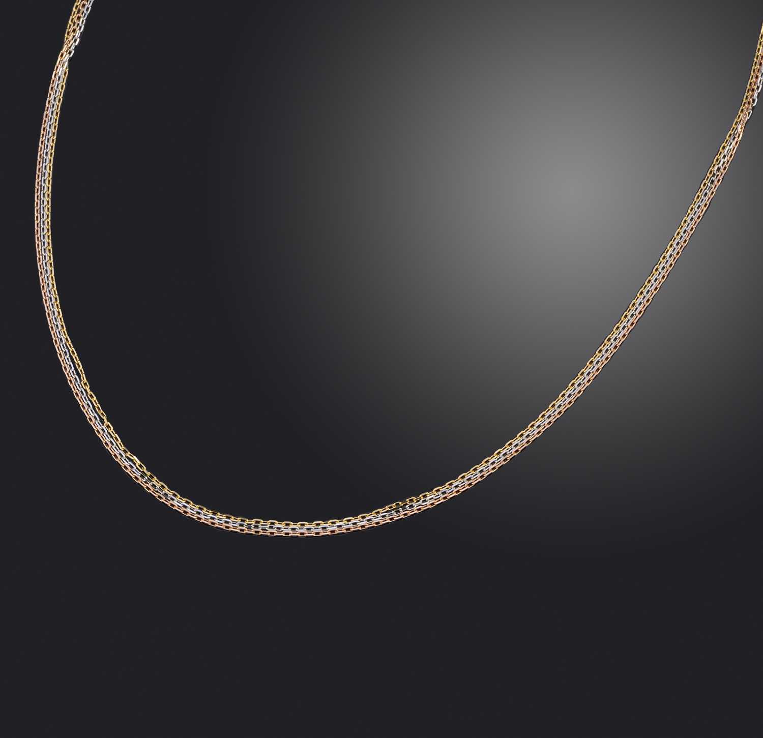 Cartier, a gold 'Trinity' necklace, formed of three fine link gold chains in yellow, white and