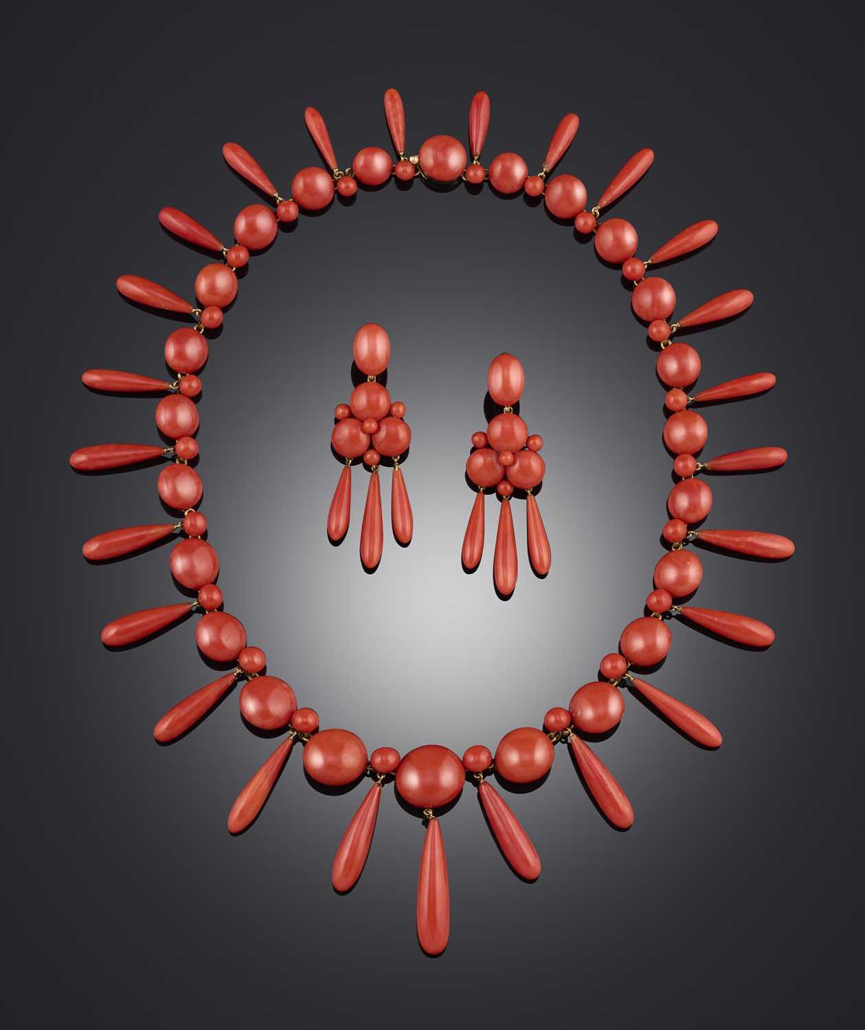 λ A fine coral demi-parure, mid 19th century, comprising: a necklace, composed of graduated bouton-