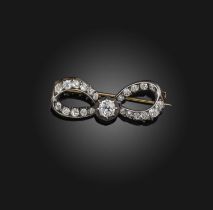 A diamond brooch, late 19th century and later, designed as a bow, set with graduated old cushion-