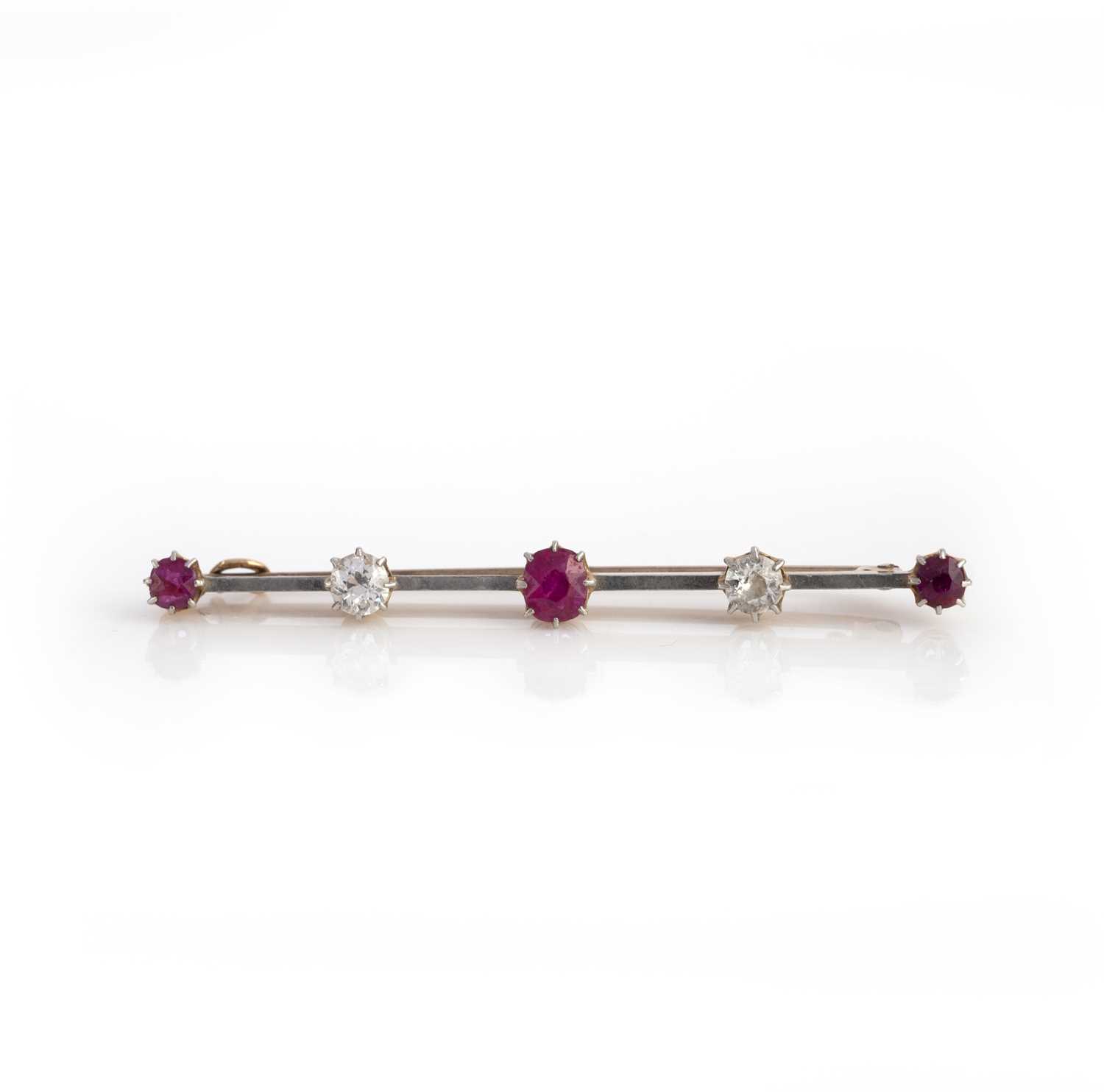 A ruby and diamond brooch, circa 1900, of bar design, set with cushion-shaped rubies and diamonds,