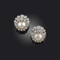 A pair of natural pearl and diamond cluster earrings, set with a button-shaped pearl within
