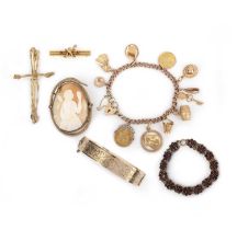 A group of jewels including a gold charm bracelet, comprising: a gold charm bracelet, suspending a