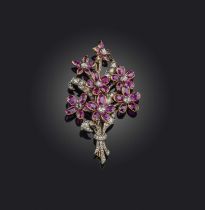 A ruby and diamond brooch, designed as a bouquet of flowers, set with rose-cut diamonds and oval
