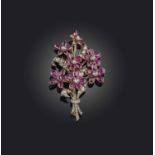 A ruby and diamond brooch, designed as a bouquet of flowers, set with rose-cut diamonds and oval