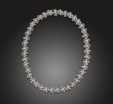 A diamond necklace, designed as a series of links designed as ribbon bows, set with brilliant-cut