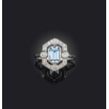 An aquamarine and diamond cluster ring, the emerald-cut aquamarine weighs approximately 0.90cts, set