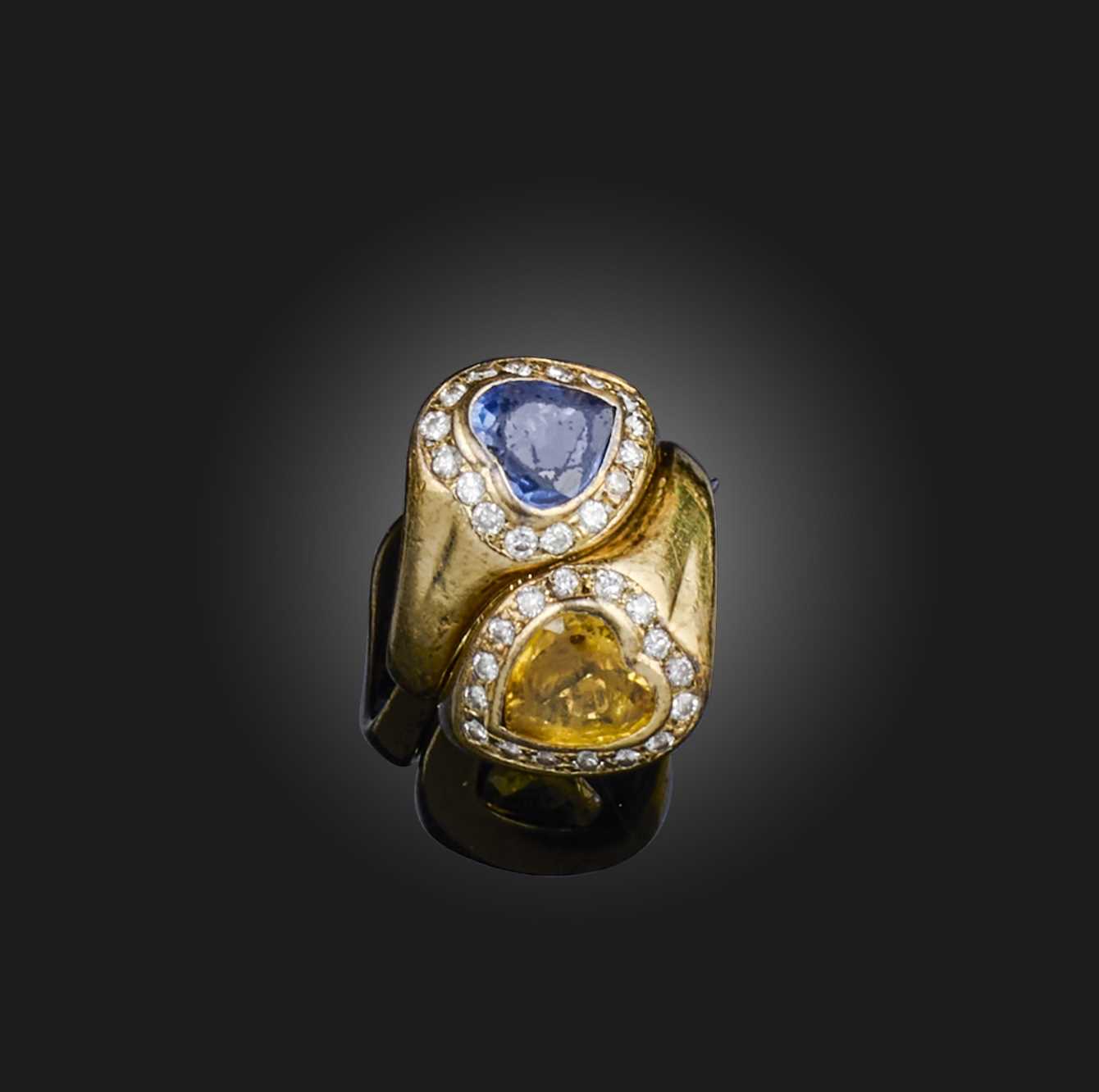Sabbadini, a sapphire and diamond ring, of crossover design, set with two heart-shaped sapphires