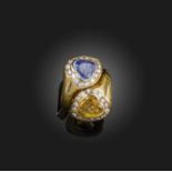 Sabbadini, a sapphire and diamond ring, of crossover design, set with two heart-shaped sapphires