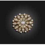 A pearl and diamond brooch, late 19th century, designed as a flower, centring on a pearl measuring