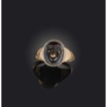 An early 19th century cameo ring, set with a banded agate cameo of a grotesque mask with a gold