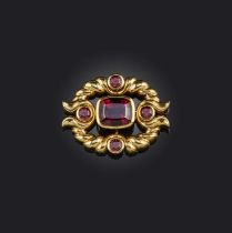 A garnet-set gold pendant, set with a central cushion-shaped almandine garnet within a twisted