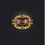 A garnet-set gold pendant, set with a central cushion-shaped almandine garnet within a twisted