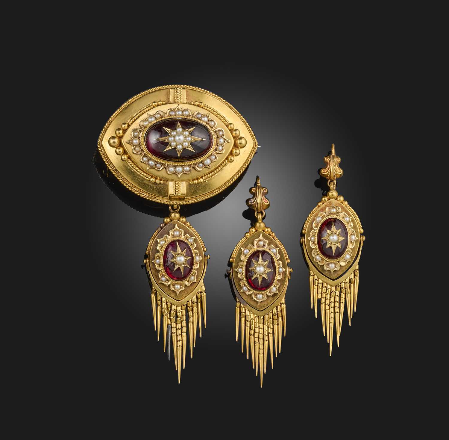 A Victorian garnet and seed pearl demi-parure, late 19th century, comprising: a pair of lozenge-