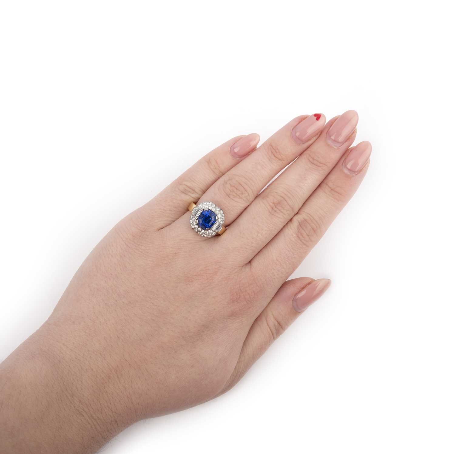 A sapphire and diamond ring, set with a step-cut sapphire measuring approximately 7.6 x 6.8 x 6.1mm, - Image 2 of 2