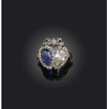 A sapphire and diamond ring, mid 19th century, designed as two conjoined hearts surmounted by a