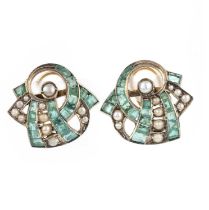A pair of emerald and pearl earrings, mid 20th century, of stylised ribbon scroll design, set with