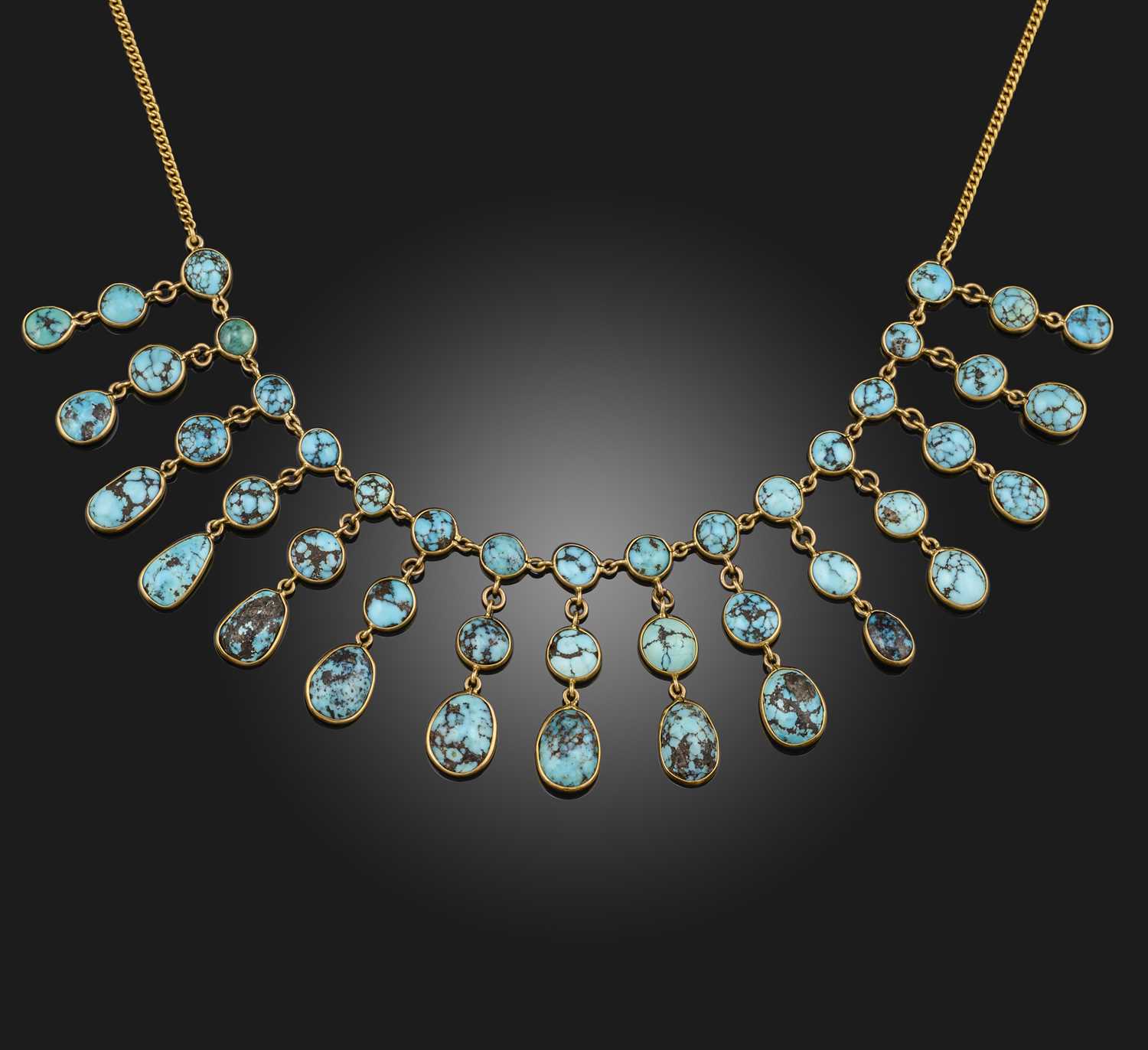 A turquoise necklace, the front suspending a fringe of turquoise cabochon pendants, to a curb link