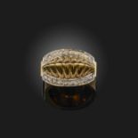 A gold and diamond ring, the centre of raised ridged design, within borders of rose-cut diamonds,
