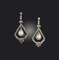 A pair of natural pearl and diamond earrings, each of foliate drop design, suspending a natural