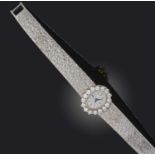 Piaget, a lady's diamond wristwatch, circa 1970, the brushed oval dial with baton indicators, within