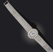 Piaget, a lady's diamond wristwatch, circa 1970, the brushed oval dial with baton indicators, within