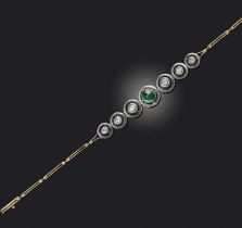 An emerald cabochon and diamond bracelet, set with a central sugarloaf emerald, within articulated